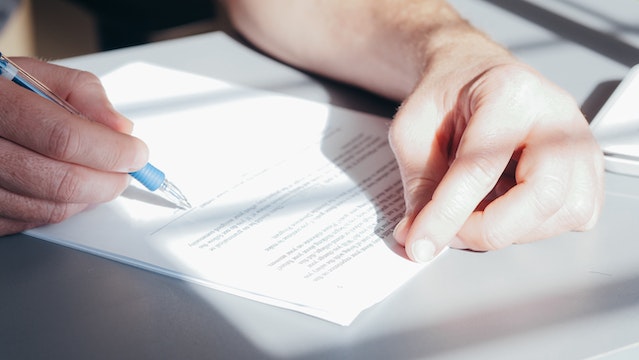 man signing trust fund